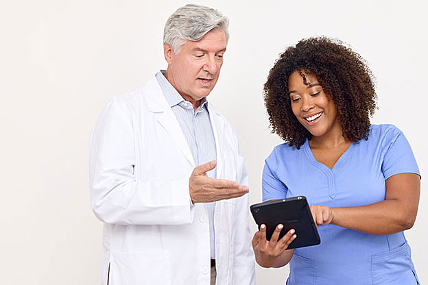 clinicians looking at tablet together